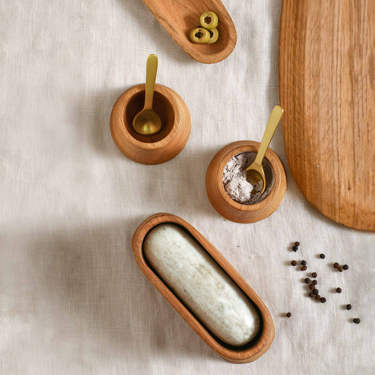 Oak Pinch Bowls with Spoons on a linen table cloth with an oak mortat and marble pestle