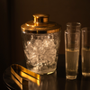Decorative pebbled glass ice bucket with tongs and hammered gold lid.